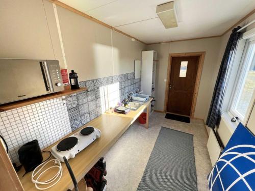 a small kitchen with a counter and a sink at Hytte Camp Nordkapp - Blue in Skarsvåg