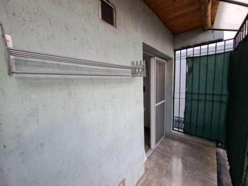 an empty room with a glass door and a window at Departamento Bombal - Centro Mendoza in Godoy Cruz