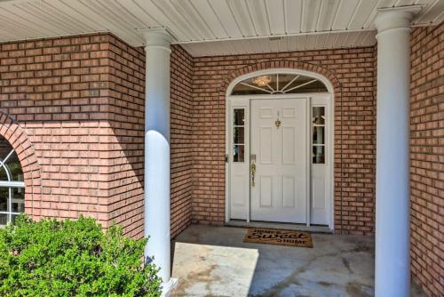 a brick house with a white door and columns at 16th and Golden in Diamondhead in Diamondhead