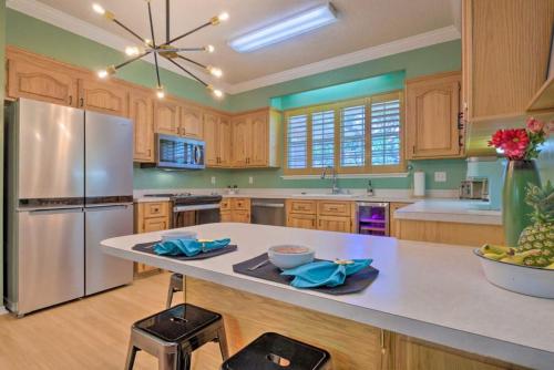 a large kitchen with wooden cabinets and a stainless steel refrigerator at 16th and Golden in Diamondhead in Diamondhead