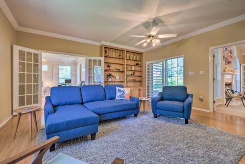 a living room with two blue chairs and a couch at 16th and Golden in Diamondhead in Diamondhead