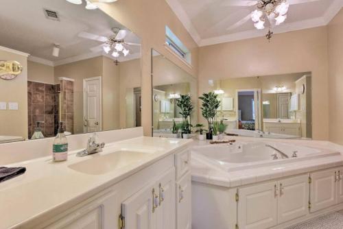 a bathroom with two sinks and a large mirror at 16th and Golden in Diamondhead in Diamondhead