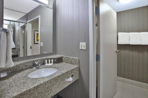 a bathroom with a sink and a mirror at Courtyard by Marriott Somerset in Somerset