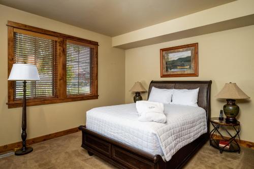 a bedroom with a bed and two windows at The Porches in Steamboat Springs