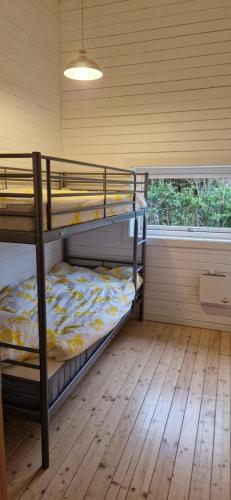 a bedroom with two bunk beds and a window at Tinymansion in Brabrand