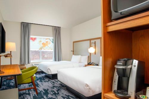 a hotel room with two beds and a television at Fairfield by Marriott Inn & Suites Harrisburg West/Mechanicsburg in Mechanicsburg