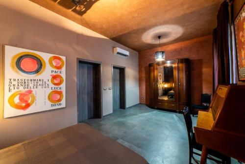 a room with a table and a painting on the wall at Speciale Tarshito's Home - Atrium and Terrace in Bari