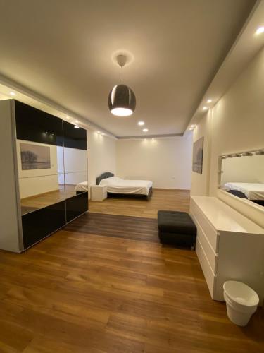 a large bedroom with a bed and a mirror at Luxurious Rooftop Appartment in Amman