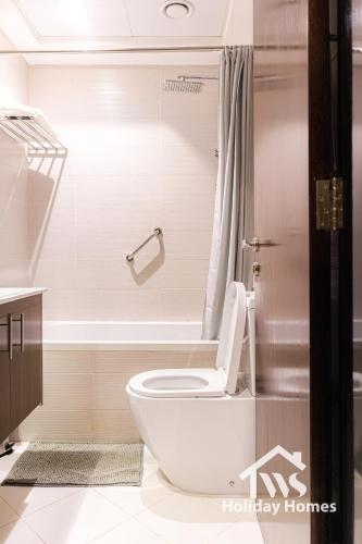 a bathroom with a toilet and a shower at The Urban Oasis - Bliss in Dubai