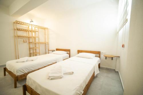 a row of three beds in a room at Nicholas Apartment Ölüdeniz in Fethiye