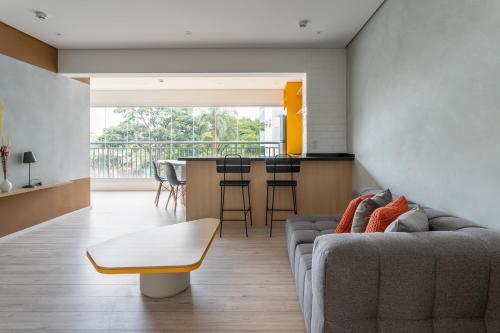 a living room with a couch and a table at Tabas - Edifício Walk SP in São Paulo