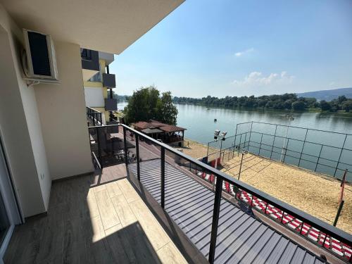 a balcony of a building with a view of a lake at Romantika 2 in Ostrovo