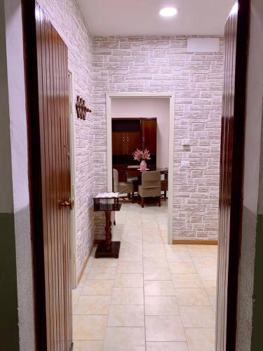 a hallway with a brick wall and a table at Il Balconcino su Spello in Spello