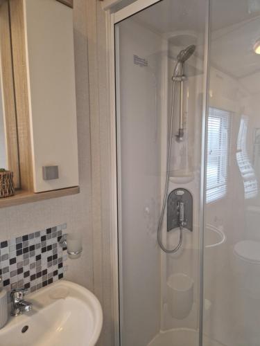a bathroom with a shower and a sink at 18 Rannoch in Forfar
