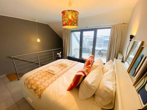 a bedroom with a large bed with a large window at Charming Apartments in City Center - S6 in Luxembourg