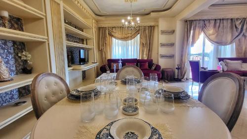 a dining room with a white table and chairs at NoVel 1 Luxury apt Katerini in Katerini