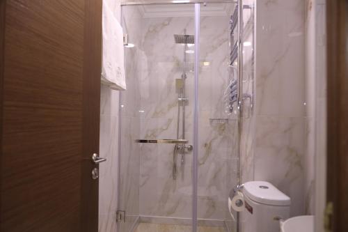 a bathroom with a glass shower with a toilet at DeLin Hotel And Tours in Yerevan