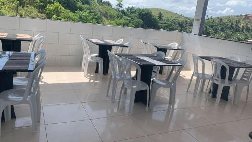 a row of tables and chairs on a patio at Pousada La Belle in Maragogi