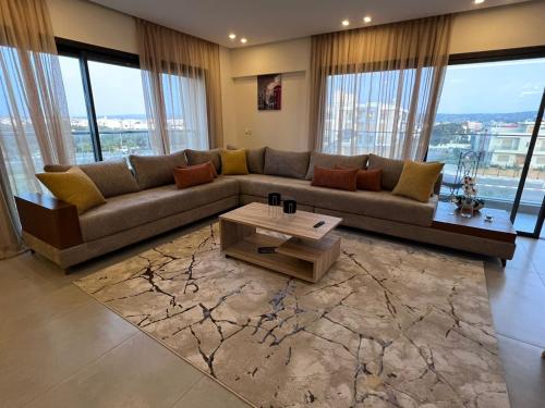 a living room with a couch and a coffee table at Appartement de luxe bord de Mer Essaouira à 2 pas de la plage in Essaouira