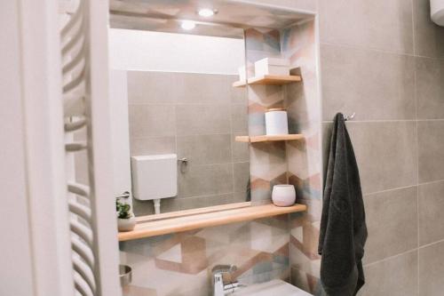 a bathroom with a mirror and a sink and a shower at Meld in Sombor