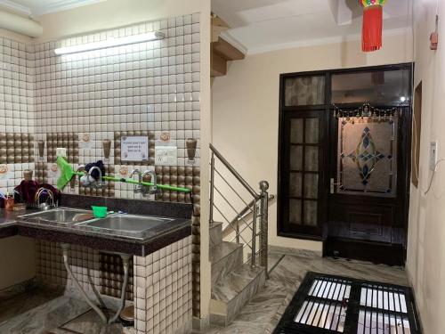a kitchen with a sink and a staircase at $4 HOME STAY (5 MINT WALK FROM GOLDEN TEMPLE) in Amritsar
