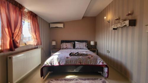 a bedroom with a bed and a window at NoVel 1 Luxury apt Katerini in Katerini