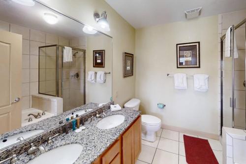 a bathroom with two sinks and a shower and a toilet at Simply Blessed Mountain View 1605 in Pigeon Forge