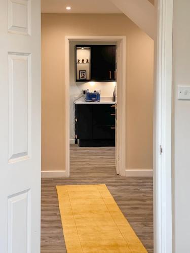 a hallway with a door leading into a room at Surrey Hills Lodge in Ewhurst
