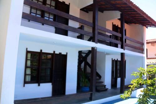 una casa con pareti bianche e finestre nere di Casa Praia Cai Nagua 8/4 a Olivença