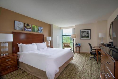 a hotel room with a large bed and a desk at Atlanta Marriott Alpharetta in Alpharetta