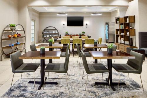 a conference room with tables and chairs and a tv at Atlanta Marriott Alpharetta in Alpharetta