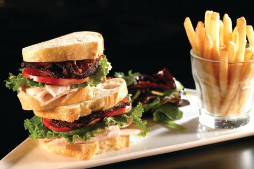 a sandwich and french fries on a white plate at Atlanta Marriott Alpharetta in Alpharetta