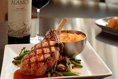 a plate of food with a piece of meat and vegetables at Atlanta Marriott Alpharetta in Alpharetta
