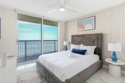 a bedroom with a large bed and a large window at Brickell Bay View Oasis with Pool Hot Tub and Gym in Miami