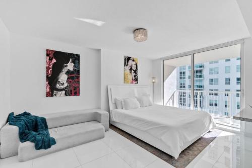 a white bedroom with a bed and a couch at Modern Sky Residence with Ocean and City Views in Miami