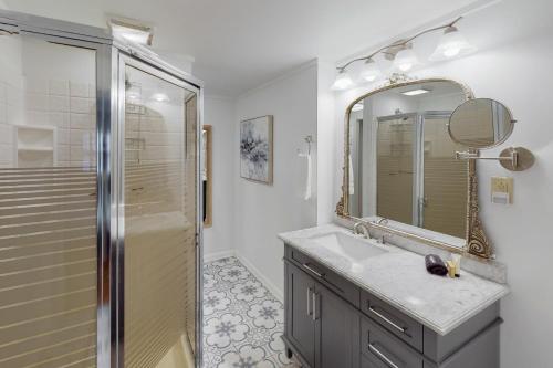 a bathroom with a sink and a shower and a mirror at Time to Chill in Nashville