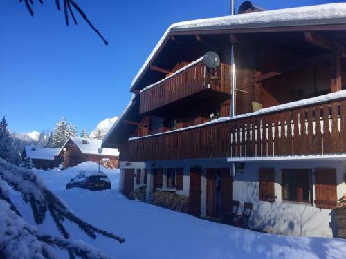a ski lodge with snow on the ground at Les Sapins - Welcoming chalet for 14p with hot tub in Châtel