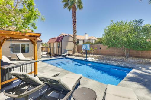 a swimming pool with chairs and a gazebo at Lovely Bullhead City Retreat with Patio and Grill! in Bullhead City