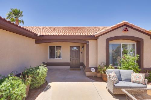a home with a porch with a door and a patio at Lovely Bullhead City Retreat with Patio and Grill! in Bullhead City