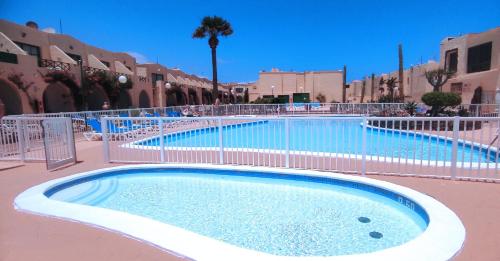 a large swimming pool with a fence around it at Castillo Mar 95 in Caleta De Fuste
