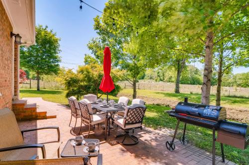 a patio with a table with chairs and a grill at 3BR 2BATH Gorgeous Country Near Nashville F1 in Franklin