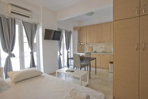 a room with a bed and a kitchen with a table at Stylish Central 2 in Athens