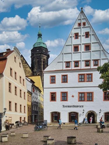 a building with a triangular roof in a city at Altstadt Domizil in Pirna