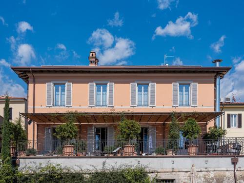 a large pink building with a balcony on top at Paradis Pietrasanta in Pietrasanta