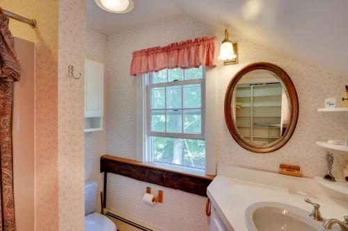 a bathroom with a sink and a mirror and a window at Waterfalls and Trails at The Mills At Green Hole in Hillsdale