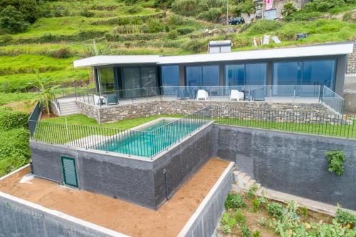 an aerial view of a house with a swimming pool at Villa Rocha in Arco da Calheta in Arco da Calheta