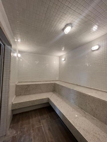 a bathroom with a long bench and tile walls at 207 EM Eco Resort in Tamandaré