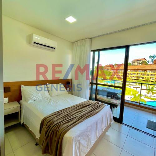 a bedroom with a bed and a large window at 207 EM Eco Resort in Tamandaré