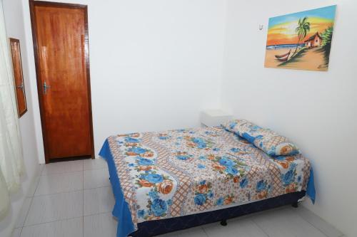 a bedroom with a bed with a quilt on it at Canoa Quebrada House in Canoa Quebrada