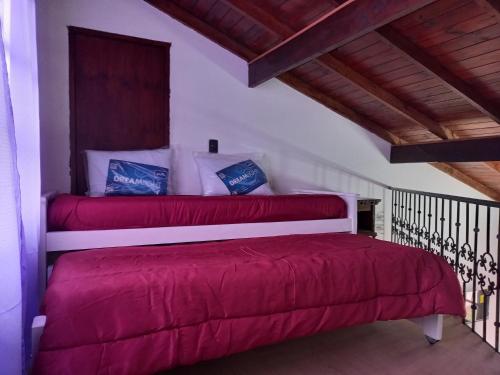 a bedroom with two beds with red sheets at Aire de mar in Mar del Plata